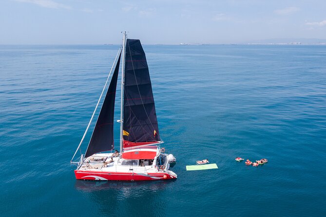 Barcelona Catamaran Cruise with Tapa & Drink Included - Sunset sailing with a drink and a small tapa