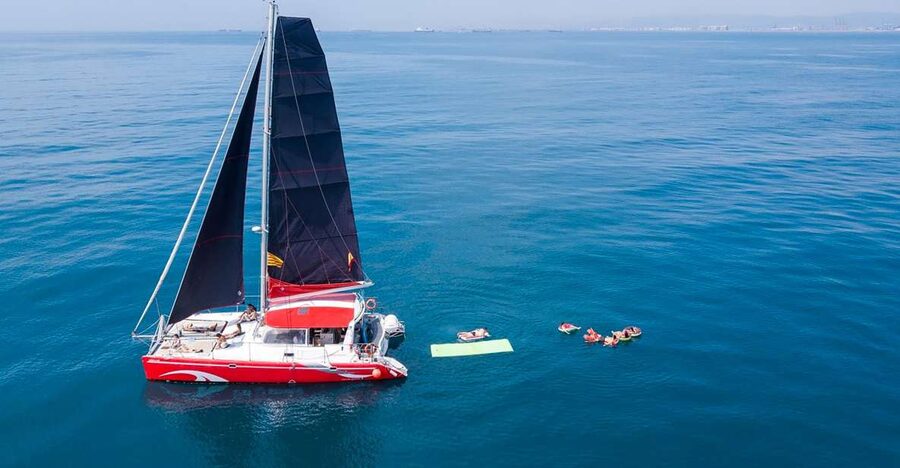 Barcelona: Sunset or Day Catamaran Cruise with Tapa & Drink - The welcome drink, music, and local tapa
