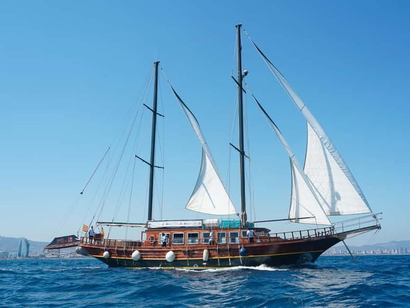 Barcelona: Wooden Boat Sailing with Tapa and Welcome Drink - Rooftop views, aft seating, and the interior lounge