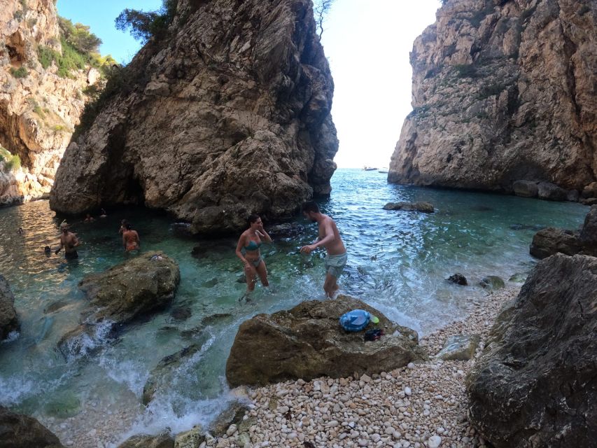 Granadella: Caló, Cova Llop Marí, and Ambolo Kayak Trip - Ambolo Beach, a short break with a clear warning