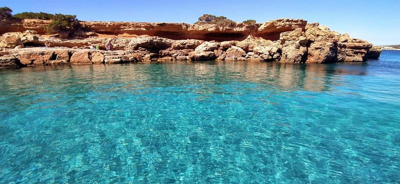 Ibiza: Snorkeling, Sunset Beach and Cave Boat Trip - Second stop: paddleboards and a rocky cove