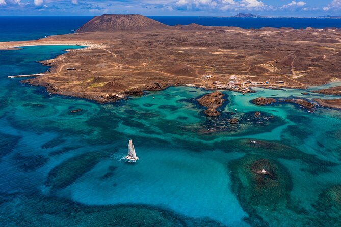 Lobos Island Half-Day Sailing Tour with Lunch - Seeing the old port, lighthouse, and volcano from the water