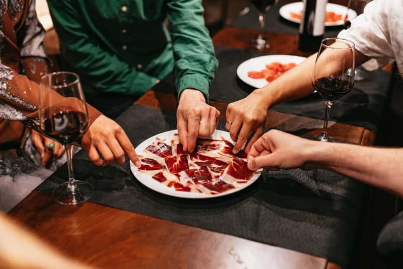 Madrid: Guided Tapas and Wine Tour with Terrace Visit - Beef cheeks and a historic bar near Huertas