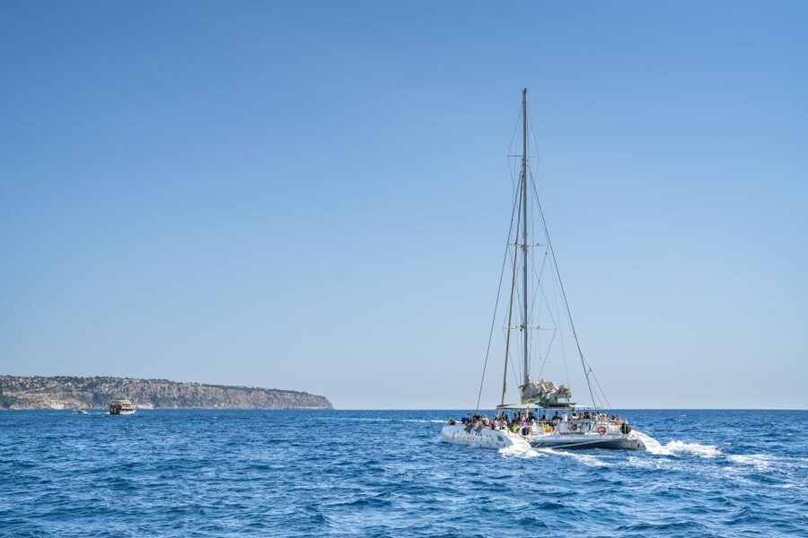 Palma de Mallorca: 5-Hour Catamaran Cruise with Lunch & Swim - Leaving Palma harbor beside yachts and cruise ships