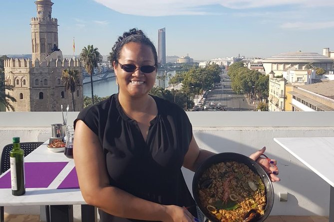 Seville: Paella Showcooking Experience - Eating paella on a Seville rooftop